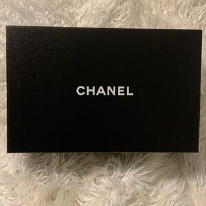 CHANEL shoe box with shoe sleeves and new set of CHANEL shoelaces.